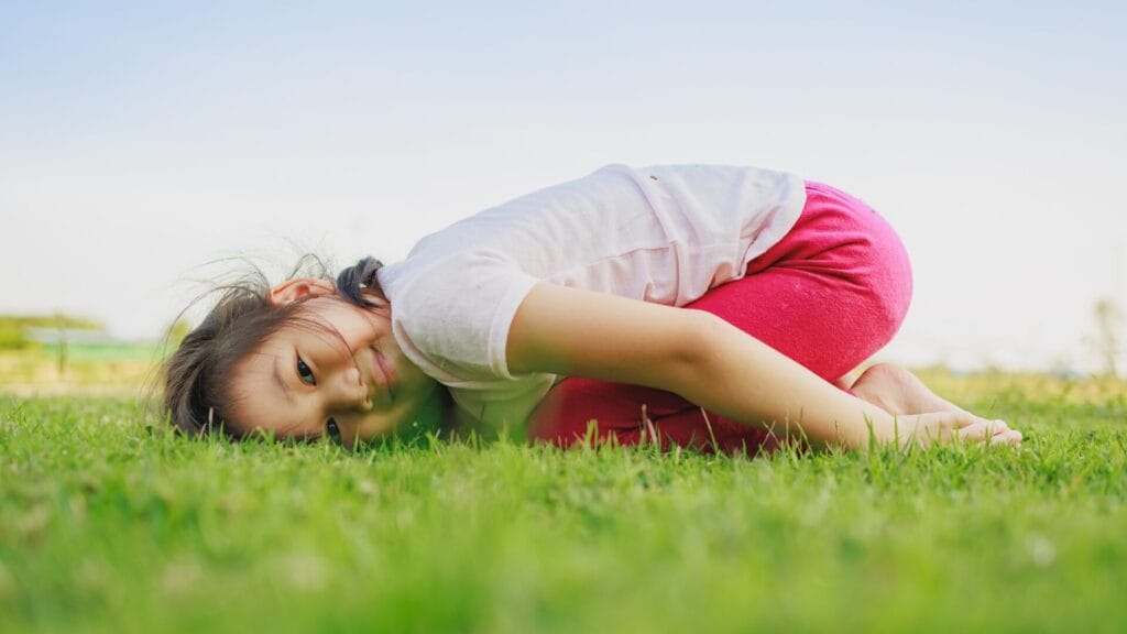 Child lying on grass, possibly experiencing grass allergies. All about grass allergies and how to get relief.